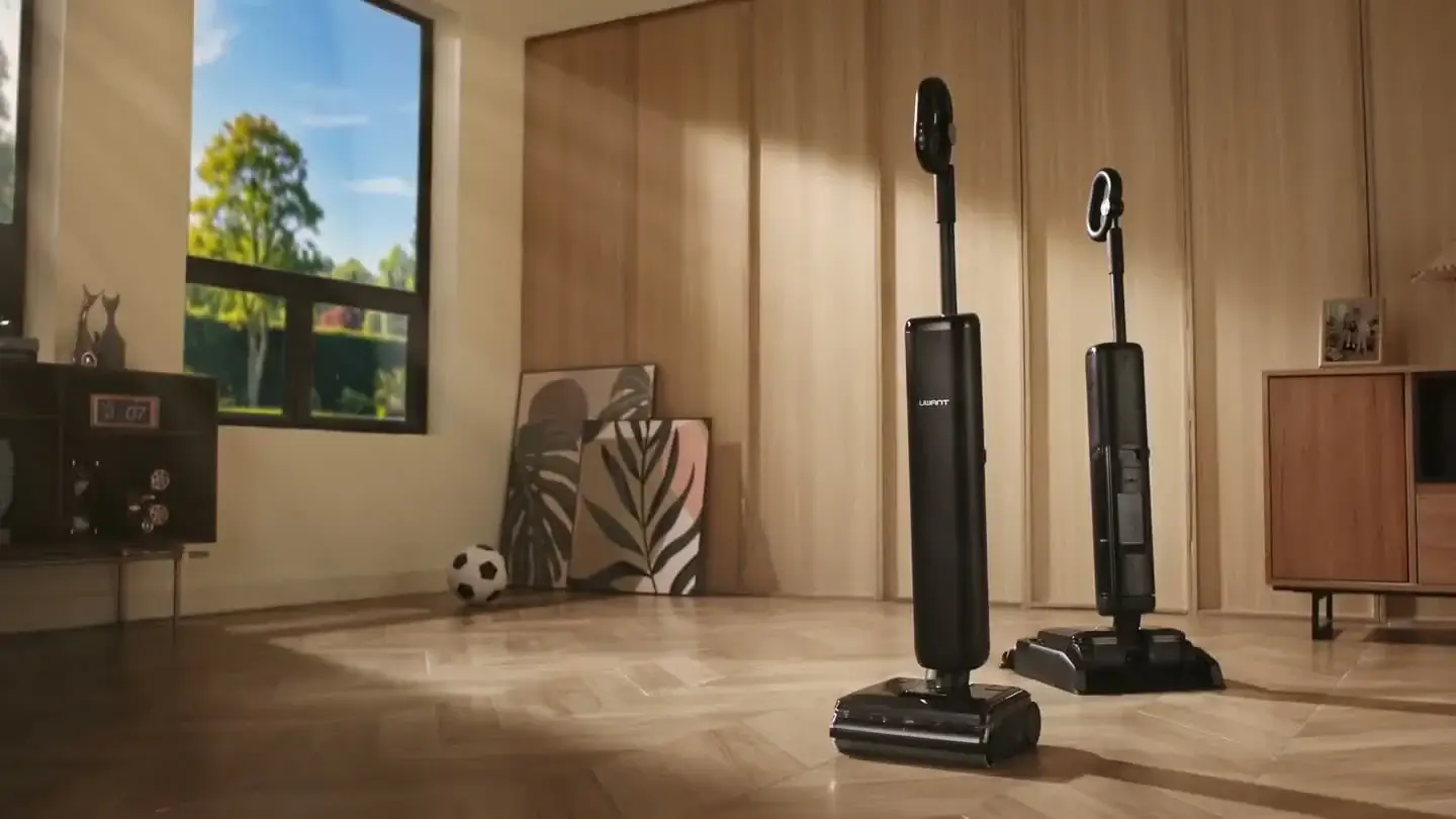 Two black UWANT floor cleaners in a sunlit room with warm wood finishes