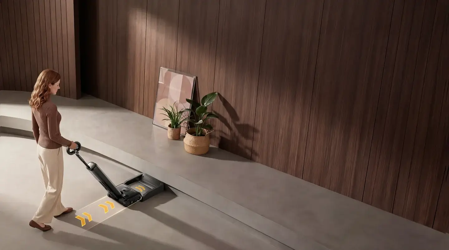 A woman using a UWANT floor cleaner in a warm wood living space