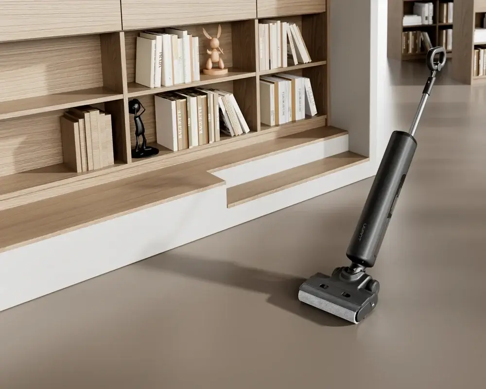 Black UWANT S600 floor cleaner beside bookshelves and a chair